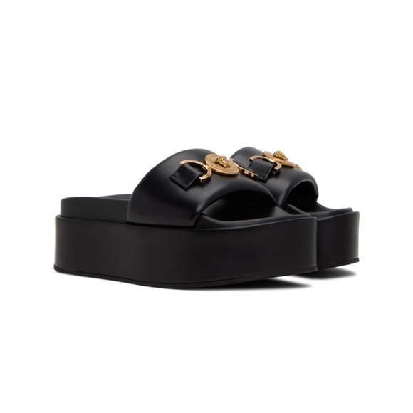Versace Buffed calfskin flat sandals in black. Signature Medusa hardware at vamp - Picture 1 of 2